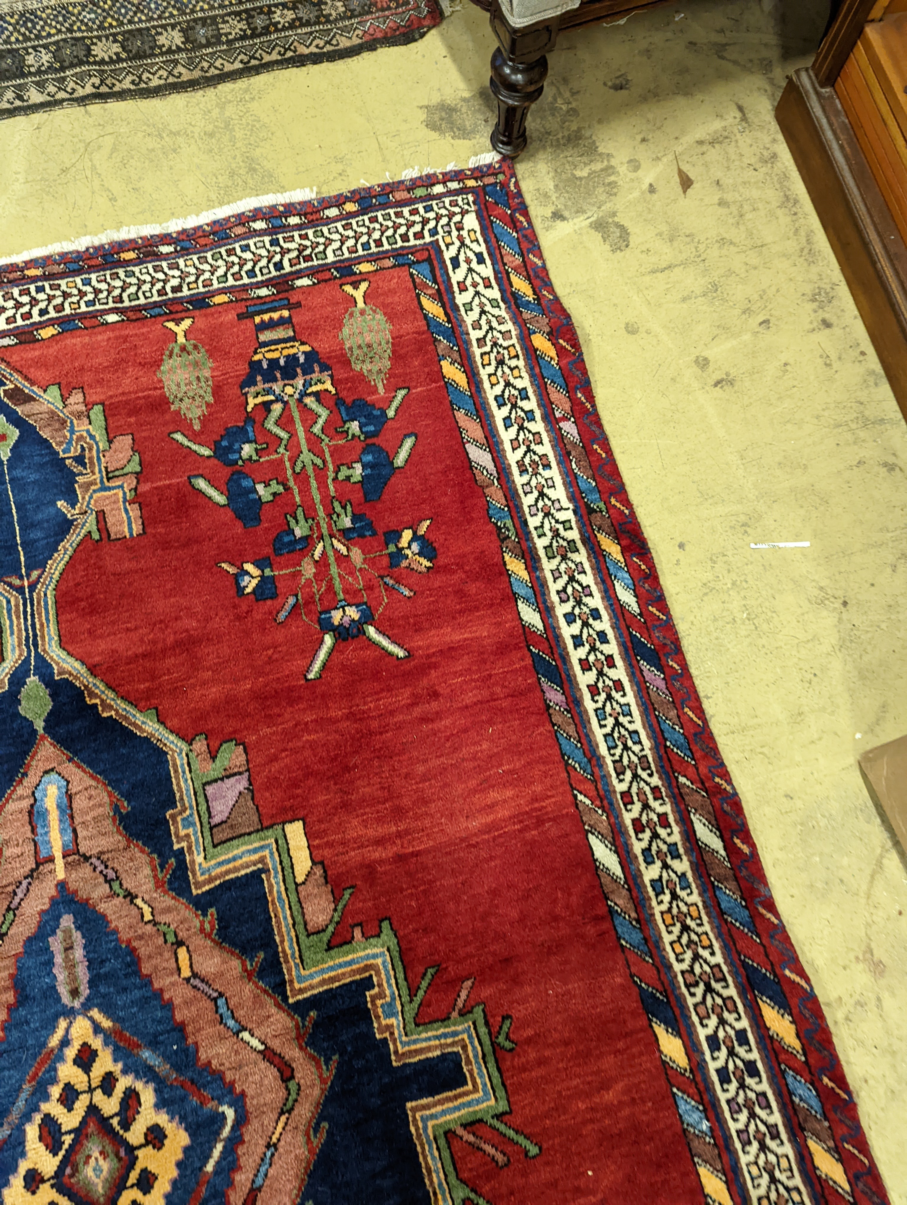 A Caucasian red ground rug, 240 x 168cm